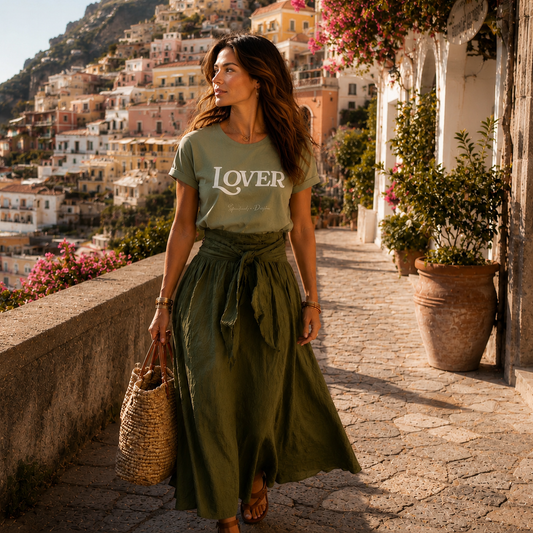 Woman in a green skirt with the Spiritual Drifter 'LOVER' shirt walking on a scenic street in Positano.