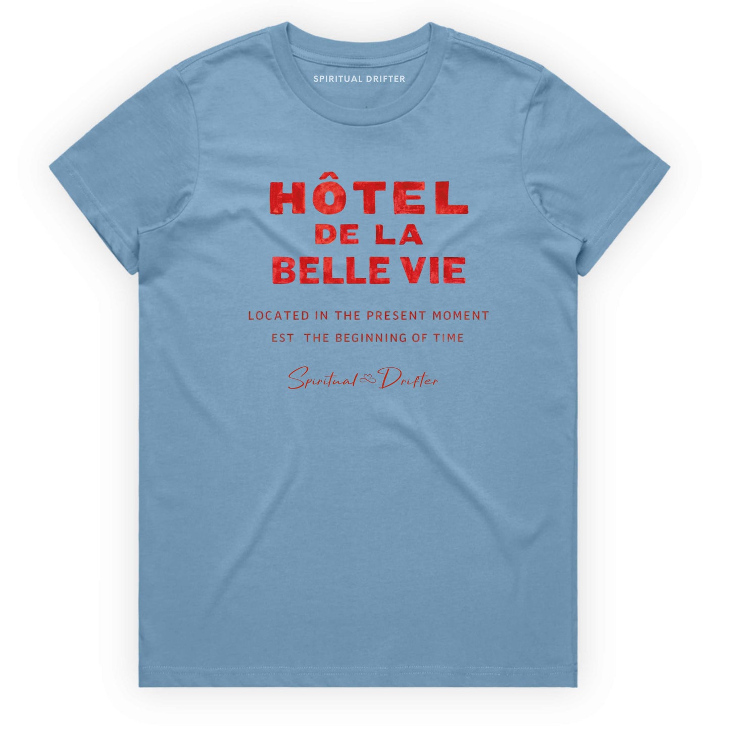 Light Blue Spiritual Drifter t-shirt with red text 'Hôtel de la Belle Vie' on a white background. Conscious clothing for awakened souls.