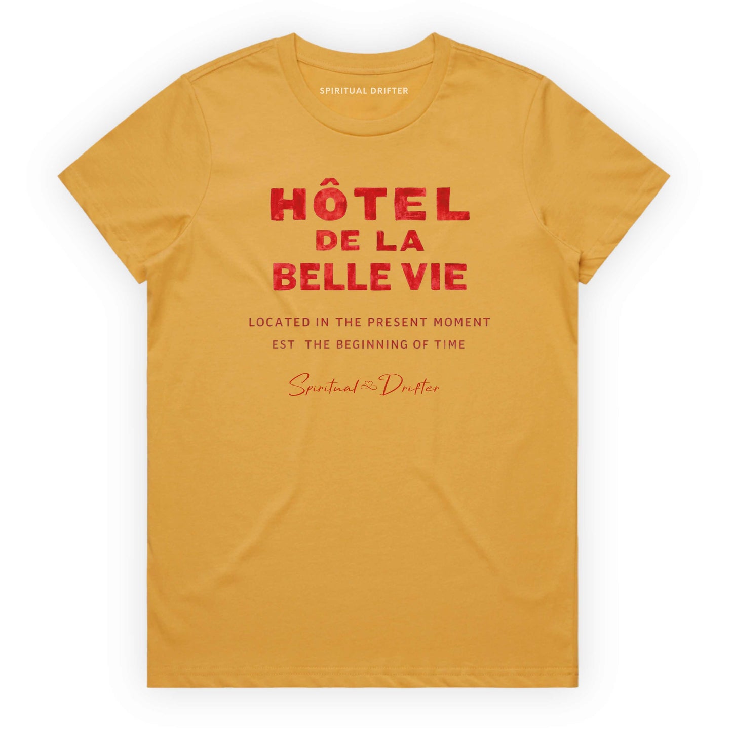 Mustard Yellow Spiritual Drifter t-shirt with red text 'Hôtel de la Belle Vie' on a white background. Conscious clothing for awakened souls.