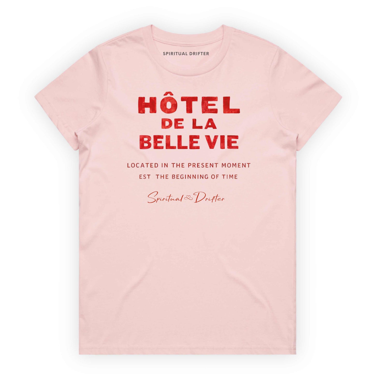Pink Spiritual Drifter t-shirt with red text 'Hôtel de la Belle Vie' on a white background. Conscious clothing for awakened souls.
