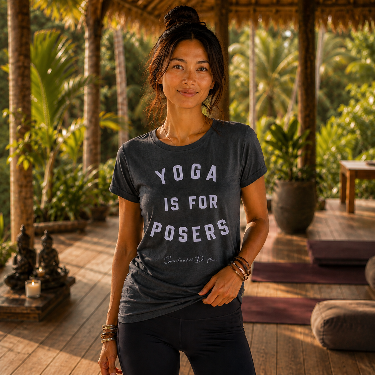 Woman wearing a Spiritual Drifter t-shirt with 'Yoga is for Posers' text in a tropical setting at a luxury retreat center n Bali Indonesia.
