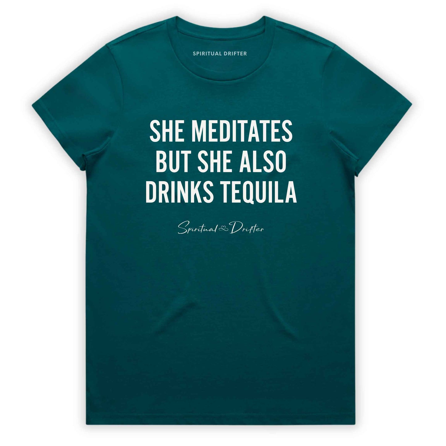 Atlantic Teal Spiritual Drifter t-shirt with white text 'SHE MEDITATES BUT SHE ALSO DRINKS TEQUILA' on a white background. Women's spiritual graphic tee. Relaxed beach lifestyle fashion for meditation lovers, yoga enthusiasts, wellness travelers, and free-spirited women. Meditation and yoga clothing for awakened souls.