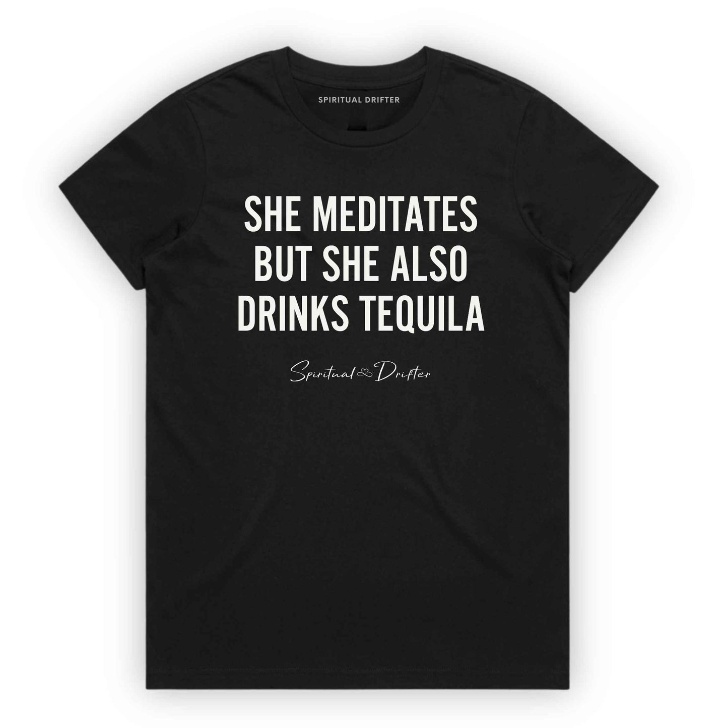 Black Soft Pink Spiritual Drifter t-shirt with white text 'SHE MEDITATES BUT SHE ALSO DRINKS TEQUILA' on a white background. Women's spiritual graphic tee. Relaxed beach lifestyle fashion for meditation lovers, yoga enthusiasts, wellness travelers, and free-spirited women. Meditation and yoga clothing for awakened souls.