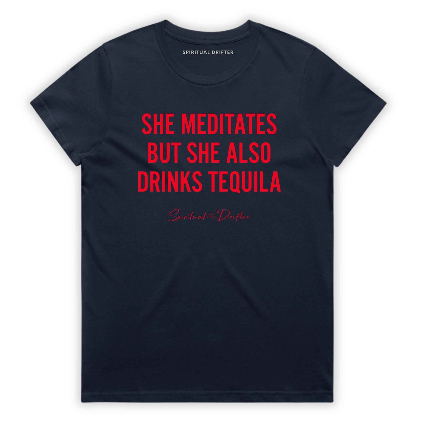 Midnight Blue Navy Spiritual Drifter t-shirt with red text 'SHE MEDITATES BUT SHE ALSO DRINKS TEQUILA' on a white background. Women's spiritual graphic tee. Relaxed beach lifestyle fashion for meditation lovers, yoga enthusiasts, wellness travelers, and free-spirited women. Meditation and yoga clothing for awakened souls.