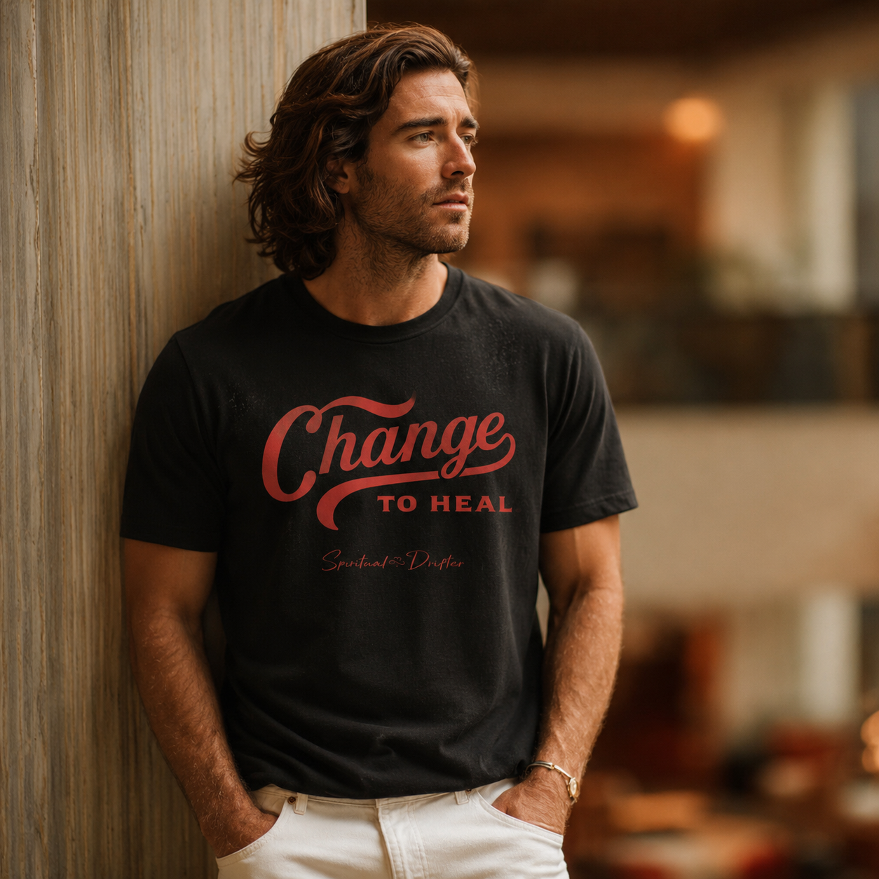 Man wearing a spiritual drifter black t-shirt with 'Change To Heal' in a luxury hotel